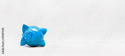 Blaues Liegendes Sparschwein auf hellem Hintergrund
