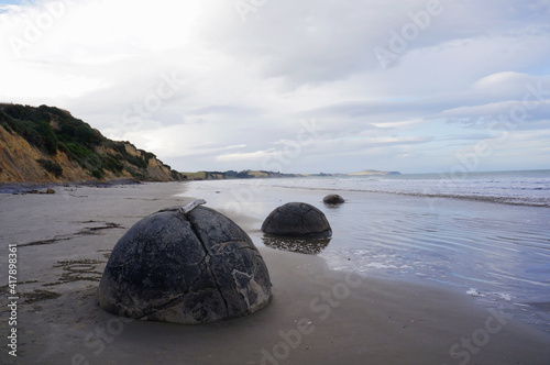 Fotografie, Obraz The Moeraki Boulders are unique large round stones lying along of Koekohe Beach