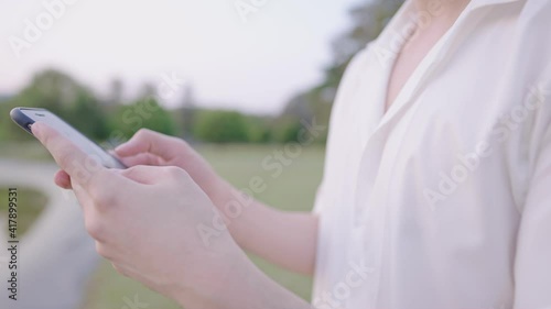 Wallpaper Mural Closeup on white skin male hands typing on phone screen while resting at natural park, relaxing exercise, recreational activity outdoor, portable information technology, distant communication device Torontodigital.ca