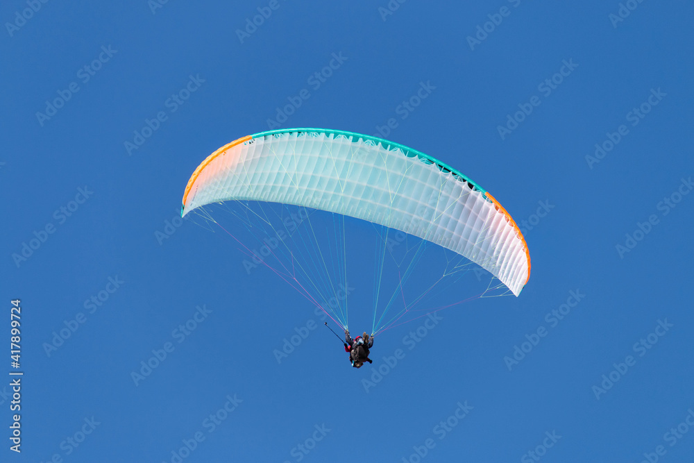 Twin paraglider. Paragliding against the blue sky. Twin paraglider. Paragliding against the blue sky.