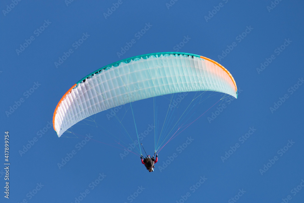 Twin paraglider. Paragliding against the blue sky. Twin paraglider. Paragliding against the blue sky.
