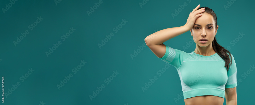 Website header of Attractive young woman in sportswear fixing her hair