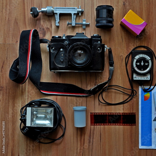 old photo accessories for film shooting with a camera with a light meter and a tripod