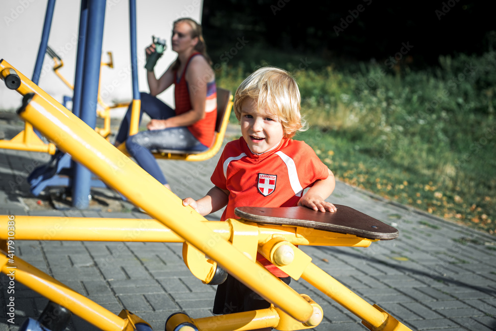 mom with a child in the park on a sports equipment, fitness, healthy lifestyle.