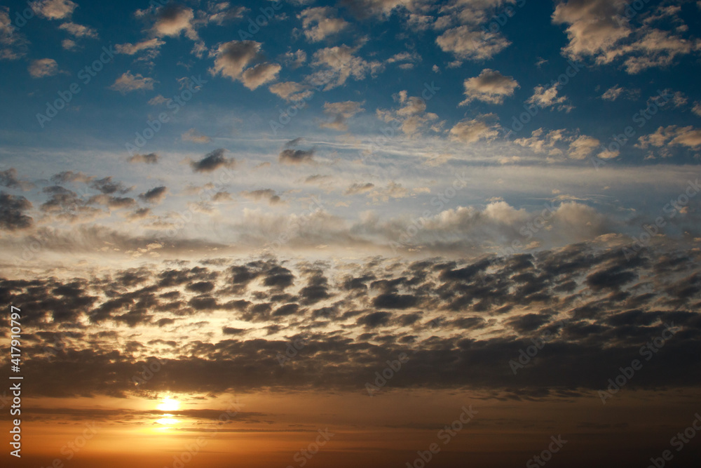 Wonderful dreamy sunrise on bright beautiful cloudy sky, purity in nature