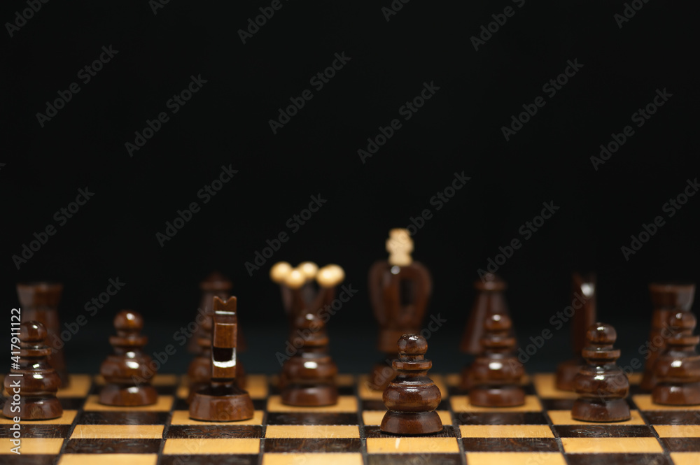 Dark pawn in the foreground and other chess pieces behind Dark pawn in the foreground and other chess pieces behind