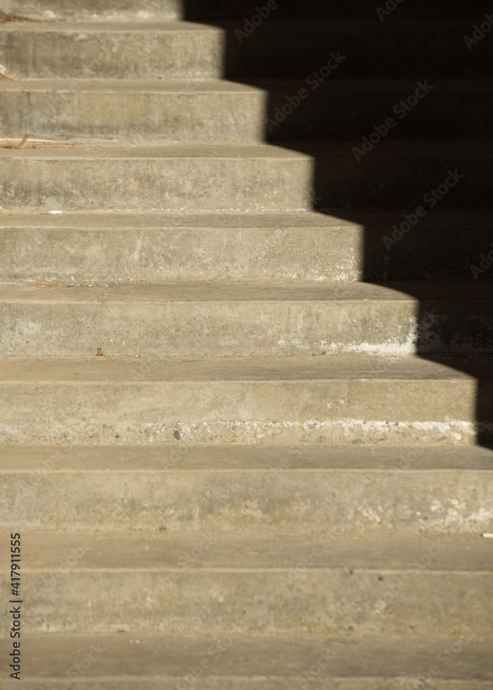 stair case in shadow showing black ridges going up and down steps black shadow background causing optical illusion of half stairs vertical format image showing perspective room for type on black stair case in shadow showing black ridges going up and down steps black shadow background causing optical illusion of half stairs vertical format image showing perspective room for type on black