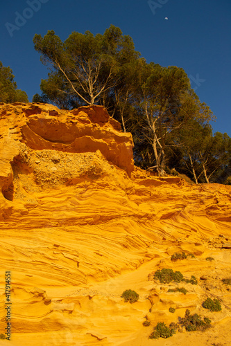 A sedimentary sandstone formation with vibrating yellow and orange colors  on a warm sunny day in the isalnd of Mallorca Spain