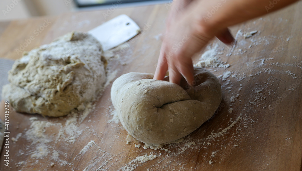 Hands of woman kneading sourdough Hands of woman kneading sourdough