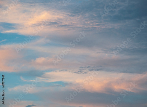 Fototapeta Naklejka Na Ścianę i Meble -  Pretty sunrise sky nature photo with clouds with pink and golden tones in blue sky.