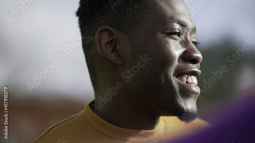 Happy black African man smiling and laughing portrait face close-up