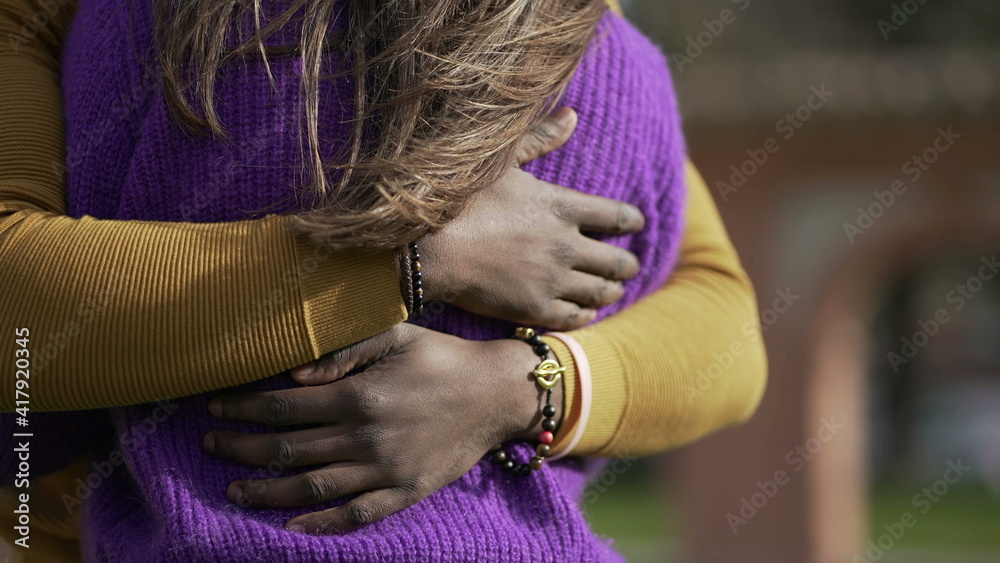 Naklejka premium Interracial couple empathic embrace. Young woman romantic connection with partner outside