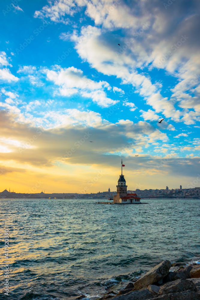 Maiden's Tower at sunset with cloudy sky. Kiz Kulesi in Istanbul. cityscape of Istanbul at sunset. Istanbul background photo. Travel to Istanbul. 