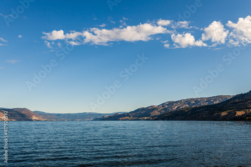 Beautiful view on lake in Canada with blue water and blue sky with white clouds