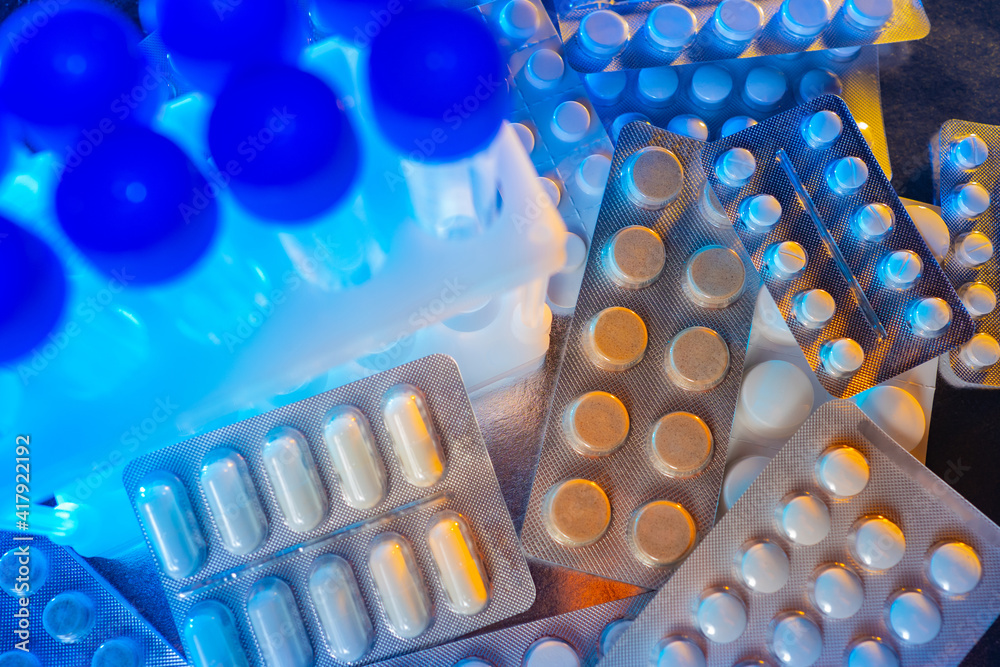 Pharmacological concept. Pills are distributed on a laboratory table