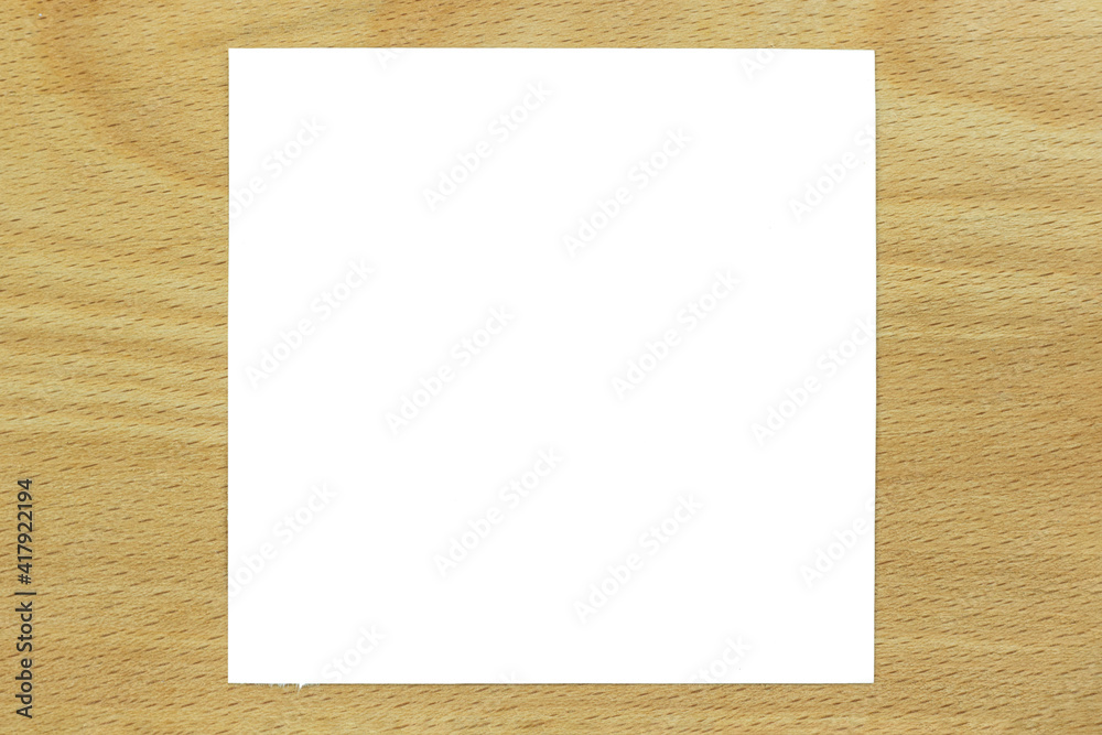 Wood texture background close up with a sheet of paper, place for text or advertising Wood texture background close up with a sheet of paper, place for text or advertising