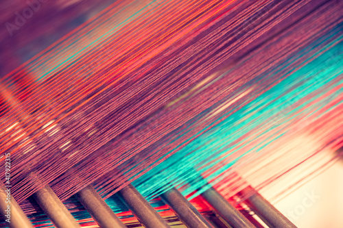 Fotografia, Obraz Multicolored straight strands texture background, sewing equipment, loom equipme