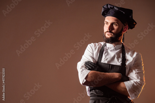 Brooding chef on a brown ba...