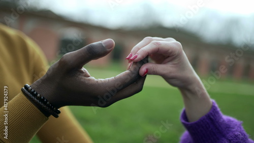 Interracial hands together caress and affection close-up © Marco