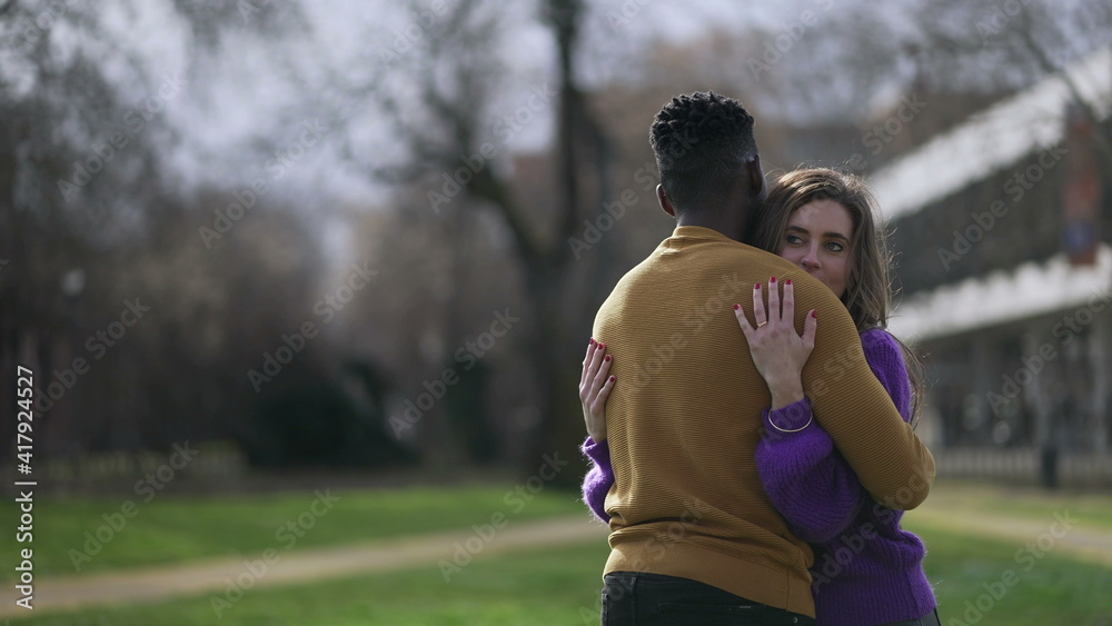 Fototapeta premium Interracial hug. Black man with while girlfriend embrace. love and affection