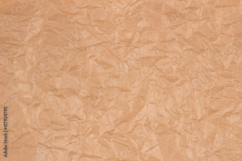 Old crumpled brown craft paper texture background. Top view