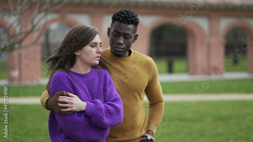 Male friend consoling depressed young woman. interracial couple partnership