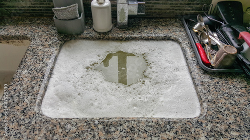 Photography Overflowing kitchen sink, clogged drain. Plumbing problems.