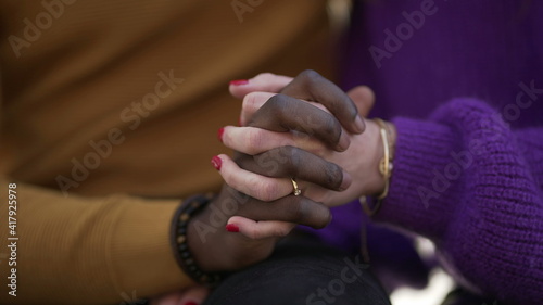 Two people joining hands together  diversity concept. interracial couple close-up hand
