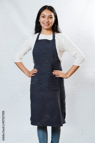 Obraz na płótnie Apron Mockup - Hispanic Woman Wearing Blue Apron - Young working woman smiling