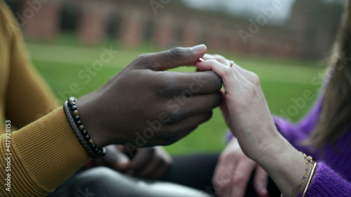 Young interracial couple holding palms and hands together. tolerance union concept
