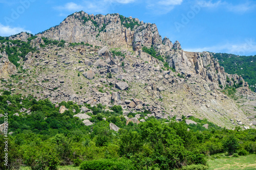 Panorama of mountains in Valley of Ghosts, near Alushta, Crimea. In central part of photo possible to see multi-ton boulders that collapsed as a result of weathering & earthquakes