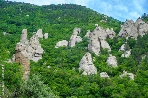 Panorama of stone erosion columns in Valley of Ghosts, near Alushta, Crimea. Strange shapes of rocks pillars were created by ages of weathering. Folk name is Devil fingers photo