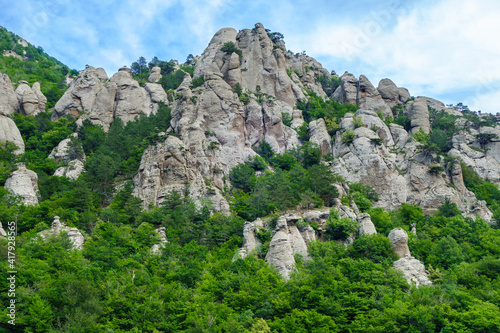 Panorama of mountains in Valley of Ghosts, near Alushta, Crimea. Rocks have tracks of ages of strong weathering. Some of them turned into stand alone so called erosion columns