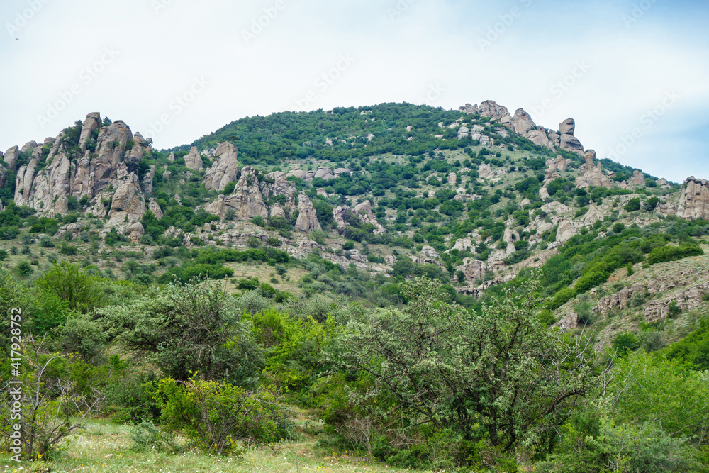Panorama of mountains in Valley of Ghosts, near Alushta, Crimea. Place popular among tourists for hiking. Some strange shaped rocks have own name. Rock named 'Head of Empress Catherine' in right side