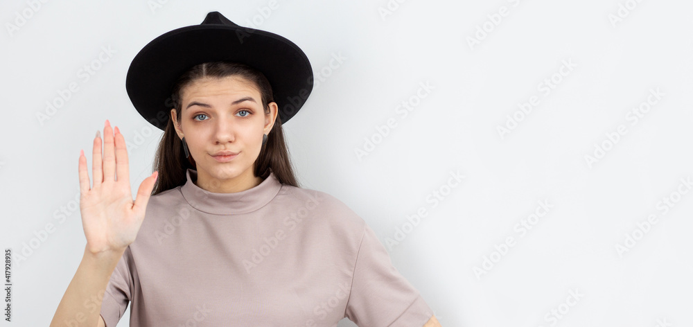 Lady making stop gesture with her palm, on a white background Lady making stop gesture with her palm, on a white background