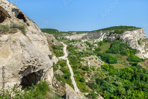 View from top of Inkerman cave monastery. Classic Crimean white rocks with plateau and caves of ancient monks inside cliff on left side. Shot near city Inkerman, Crimea photo