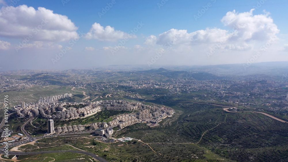 Jerusalem and Betlehem city wide aerial flight view
Drone high altitude view,clouds mountains, betlehem and Blue skies March 2021 Israel
