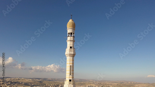 Mosque Tower minaret in Anata Refugees Camp, Jerusalem,aerial view Drone view from east Jerusalem, close to pisgat zeev neighbourhood, Judean desert  © ImageBank4U