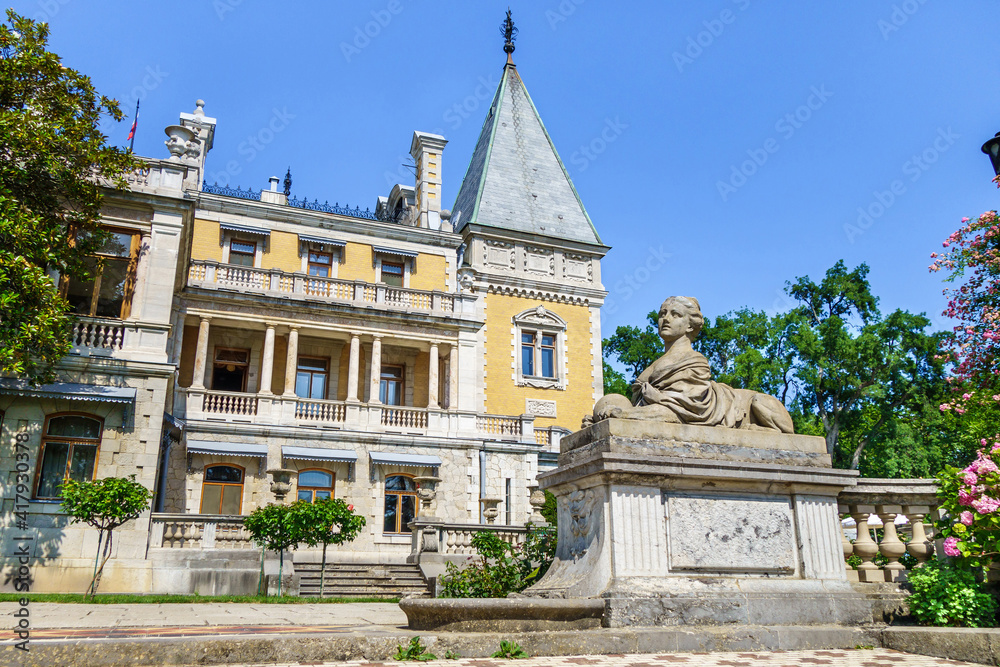 Panorama of Massandra palace in baroque style with its park and statue of sphinx with female head. Building founded in 1881. Shot in Massandra, near Yalta, Crimea