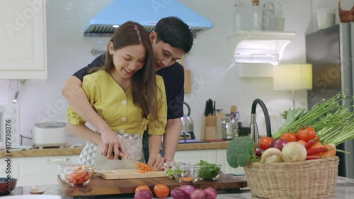 A lovely couple Are helping to prepare ingredients for cooking In a romantic atmosphere in the kitchen at home.