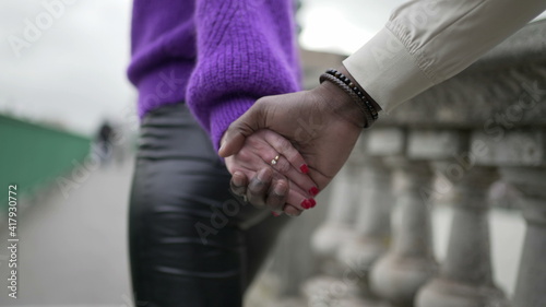 Young woman leading man hands holding and running together