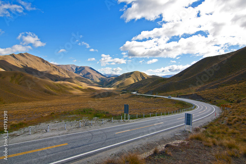 Scenic road at the Lindis Pass through the mountains in New Zealand