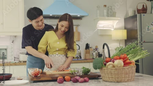 A lovely couple Are helping to prepare ingredients for cooking In a romantic atmosphere in the kitchen at home.