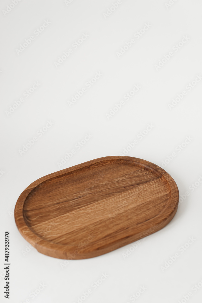 Comfortable wooden tray on a white background. Dishes made of ash wood. Wooden utensils. Comfortable wooden tray on a white background. Dishes made of ash wood. Wooden utensils.