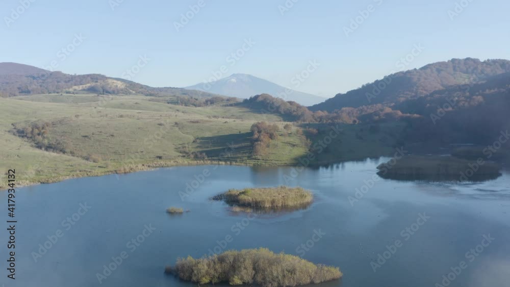 Lake Biviere in the heart of the Nebrodi mountains in Sicily. Lake in autumn with a view of the Etna volcano and the background of the Rocche del Crasto, the Tyrrhenian sea and the Aeolian Islands. Lake Biviere in the heart of the Nebrodi mountains in Sicily. Lake in autumn with a view of the Etna volcano and the background of the Rocche del Crasto, the Tyrrhenian sea and the Aeolian Islands.