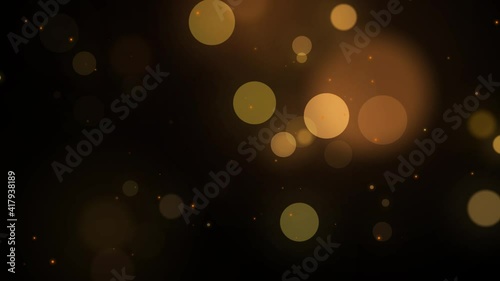 Abstract Gold blurry bokeh background with lights particles on dark background. Defocused photo effect. Slow motion animation photo