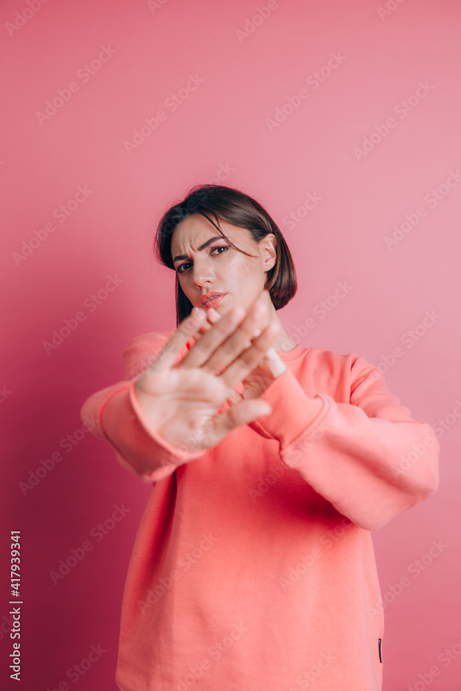Woman wearing casual sweater on background disgusted expression, displeased and fearful doing disgust face because aversion reaction Woman wearing casual sweater on background disgusted expression, displeased and fearful doing disgust face because aversion reaction