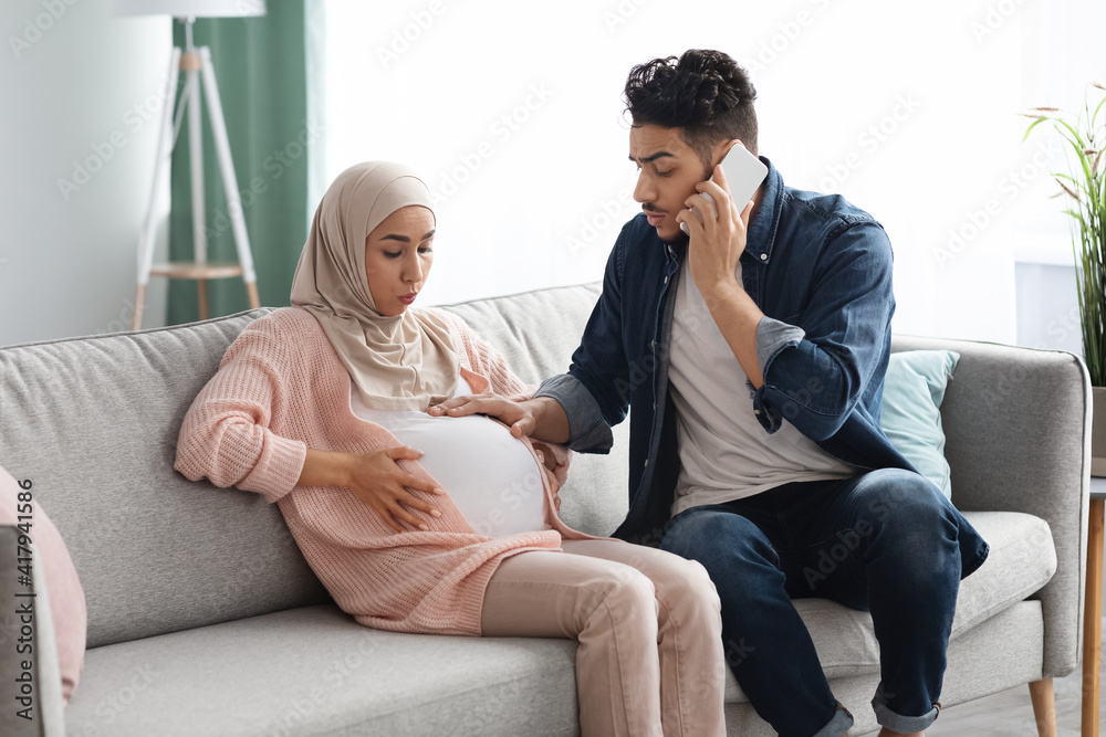 Pregnant Muslim Lady Having Prenatal Contractions At Home, Her Husband Calling Emergency Pregnant Muslim Lady Having Prenatal Contractions At Home, Her Husband Calling Emergency