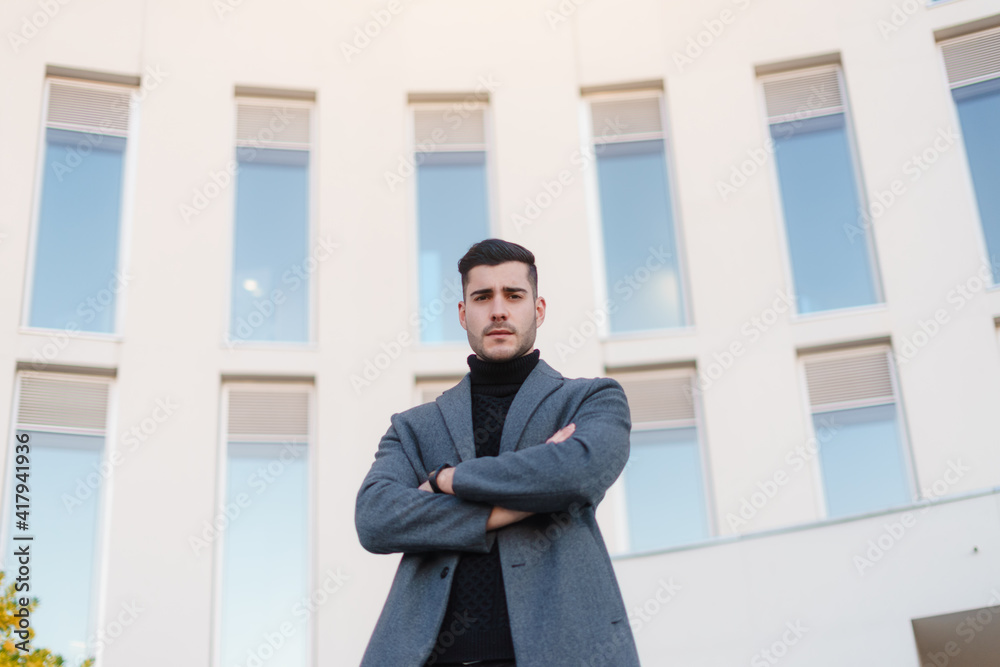 Businessman with crossed arms in corporate pose. Businessman with crossed arms in corporate pose.