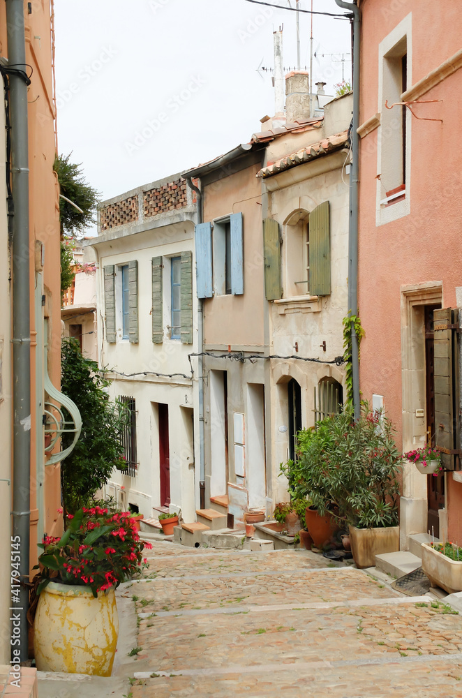 A narrow cobblestone street in a village in Provence